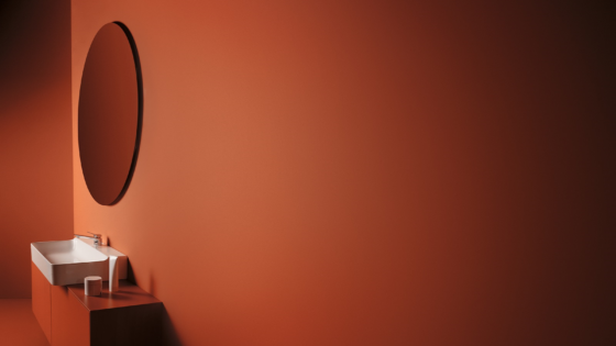 conca mirror from Ideal Standard on rust painted wall