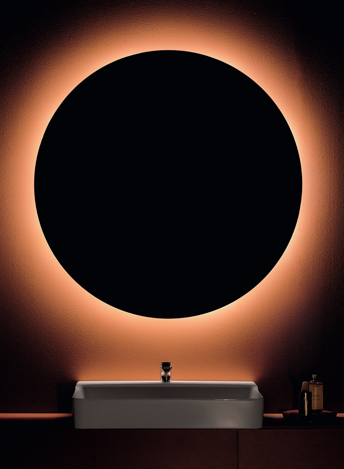 conca mirror in dark silhouette with backlit edge