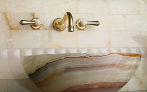 brass taps above marble basin from House of Rohl - Perrin & Rowe