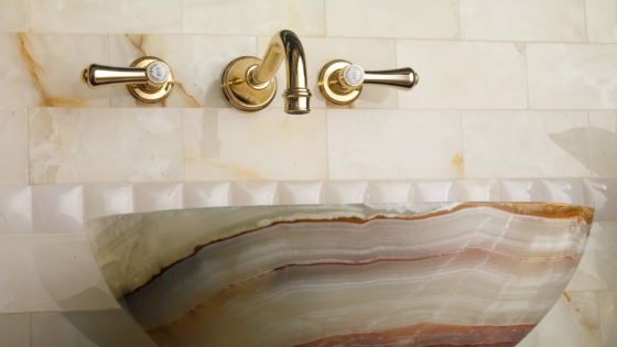 brass taps above marble basin from House of Rohl - Perrin & Rowe