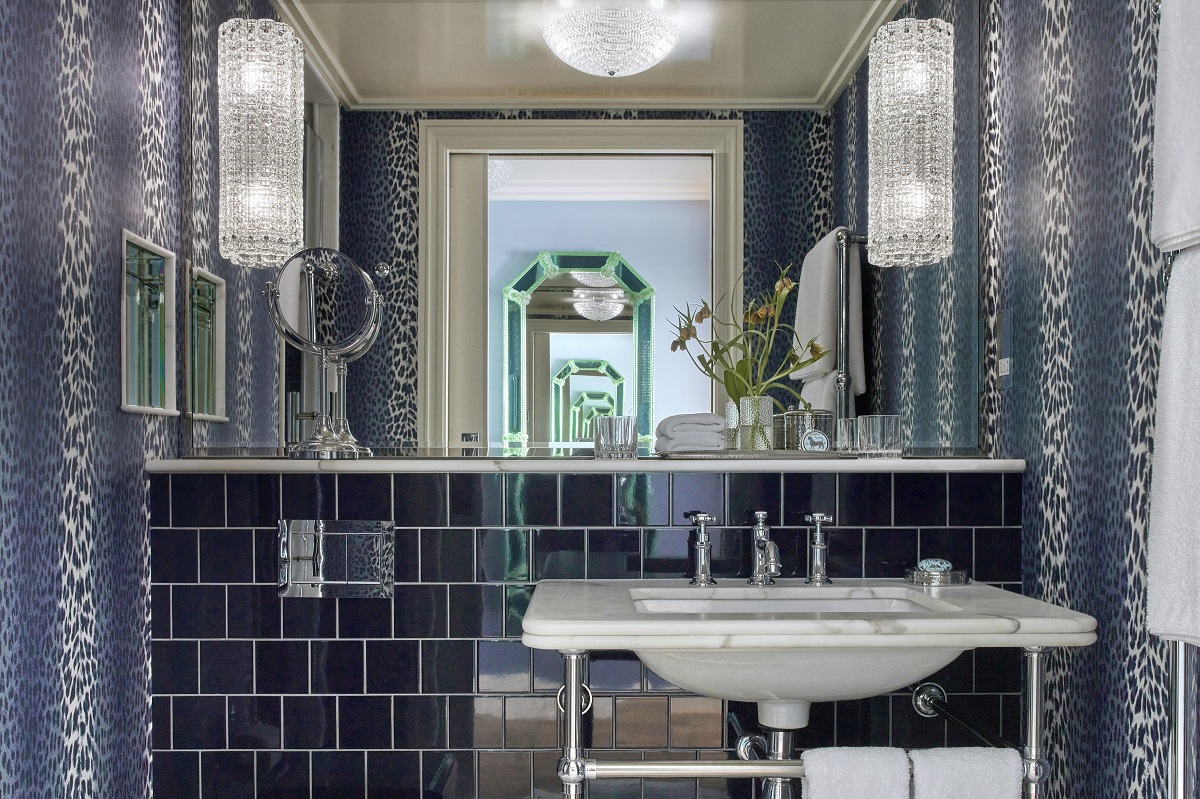 bathroom with blue tiles and blue leopard print wallcovering