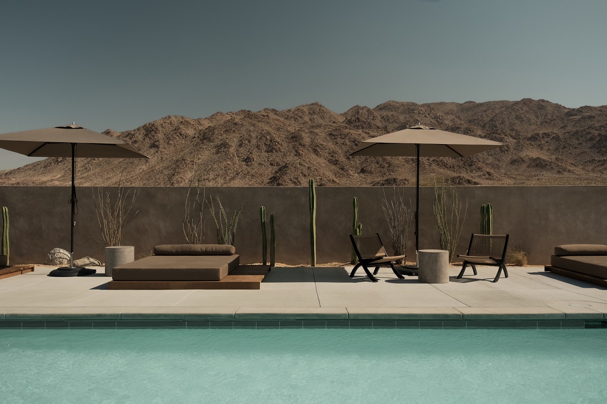 RESET Hotel pool and parasols with Joshua Tree Landscape