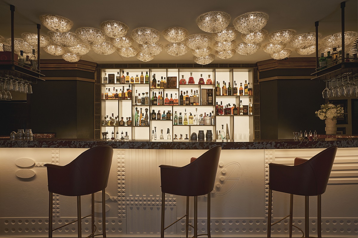 backlit and with statement ceiling lighting in the Carlton Bar Milan