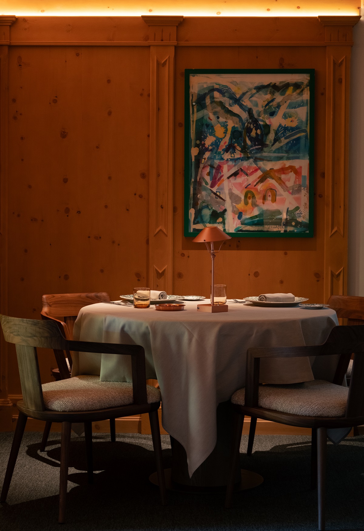 contemporary art on pine panelled wall in hotel dining room