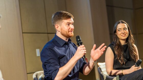 artiq on stage discussing art in hotels