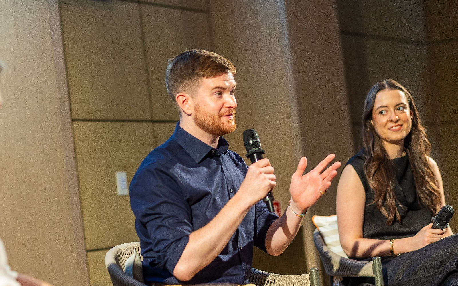 artiq on stage discussing art in hotels