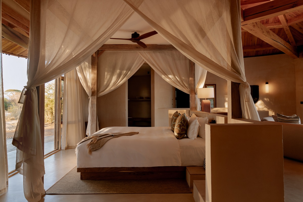 tented bedroom at Ubuyu with white cotton drapes around the bed