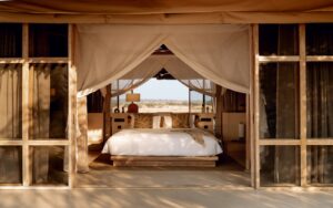 view of bed in tented guestroom at Ubuyu from Banyan Group