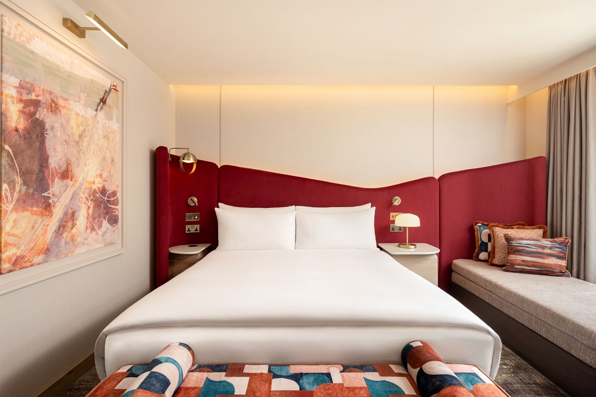 King Superior Room with statement burgundy headboard