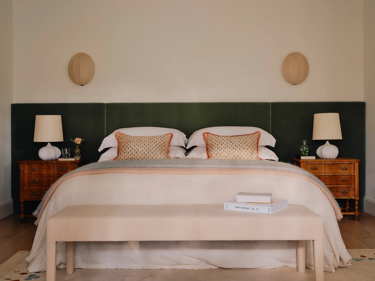 floral carpet underpinning green headboard in bedroom designed by Emma Ainscough