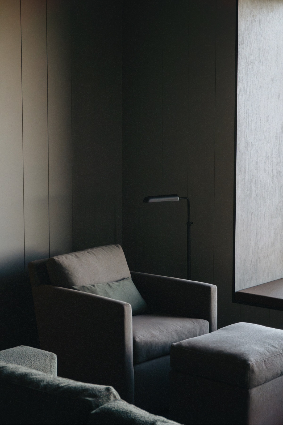 monochrome interior with slate chair against wood panel in 360 Hotel Iceland