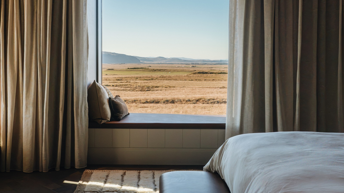 bed and window seat with panoramic icelandic view in 360 Hotel