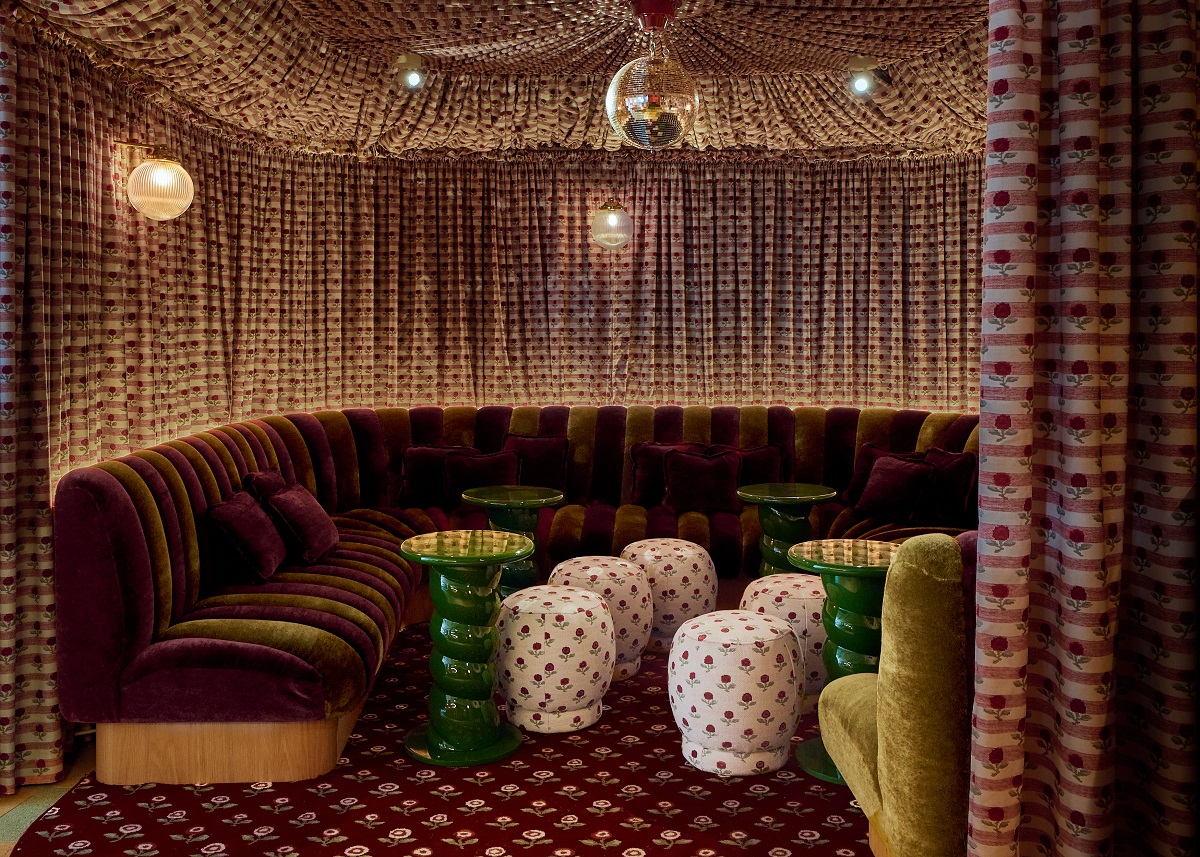 seating in alcove with Pierre frey draped fabric and disco ball
