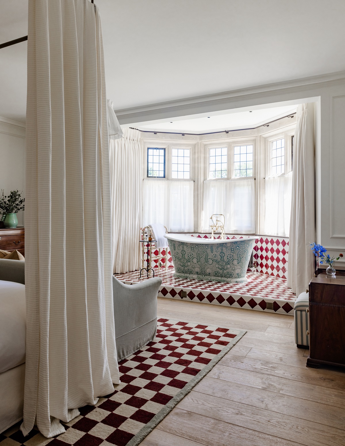 Checked red and white run under bed to match tiles in bath alcove in kin house