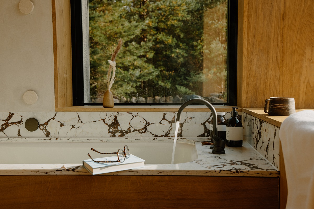 bathroom in wood and marble with forest view