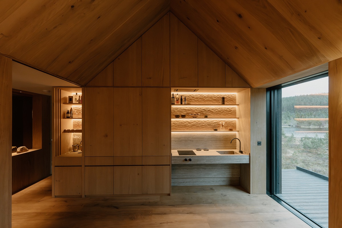 pitched wooden ceiling with backlit kitchen alcove