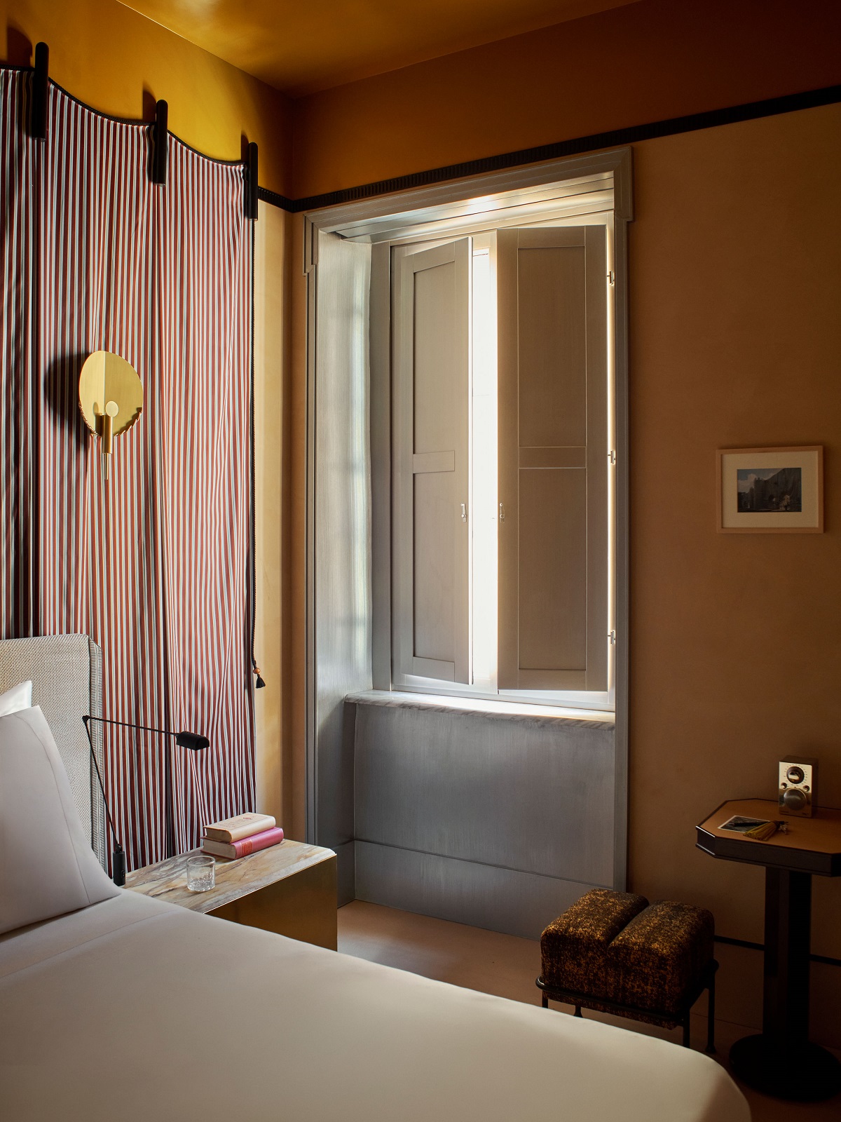 bed and window with draped detail in guestroom