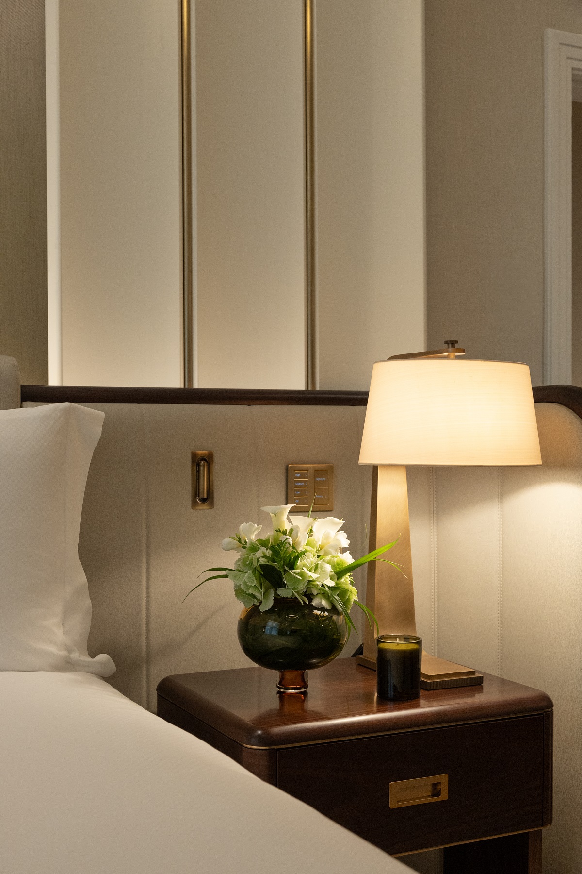 bedside light and flowers next to the bed in The Savoy London