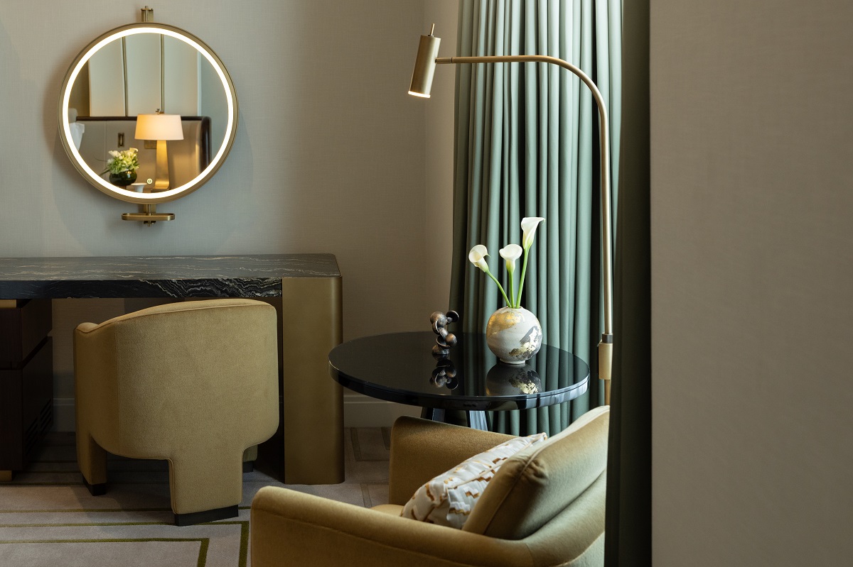 desk with mirror and seating in guestroom at The Savoy London