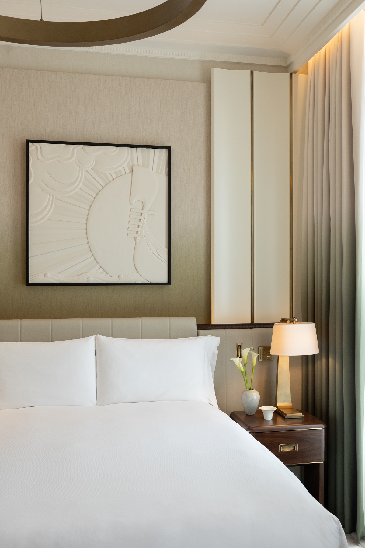 bed, art above the bed and table detail in The Savoy London