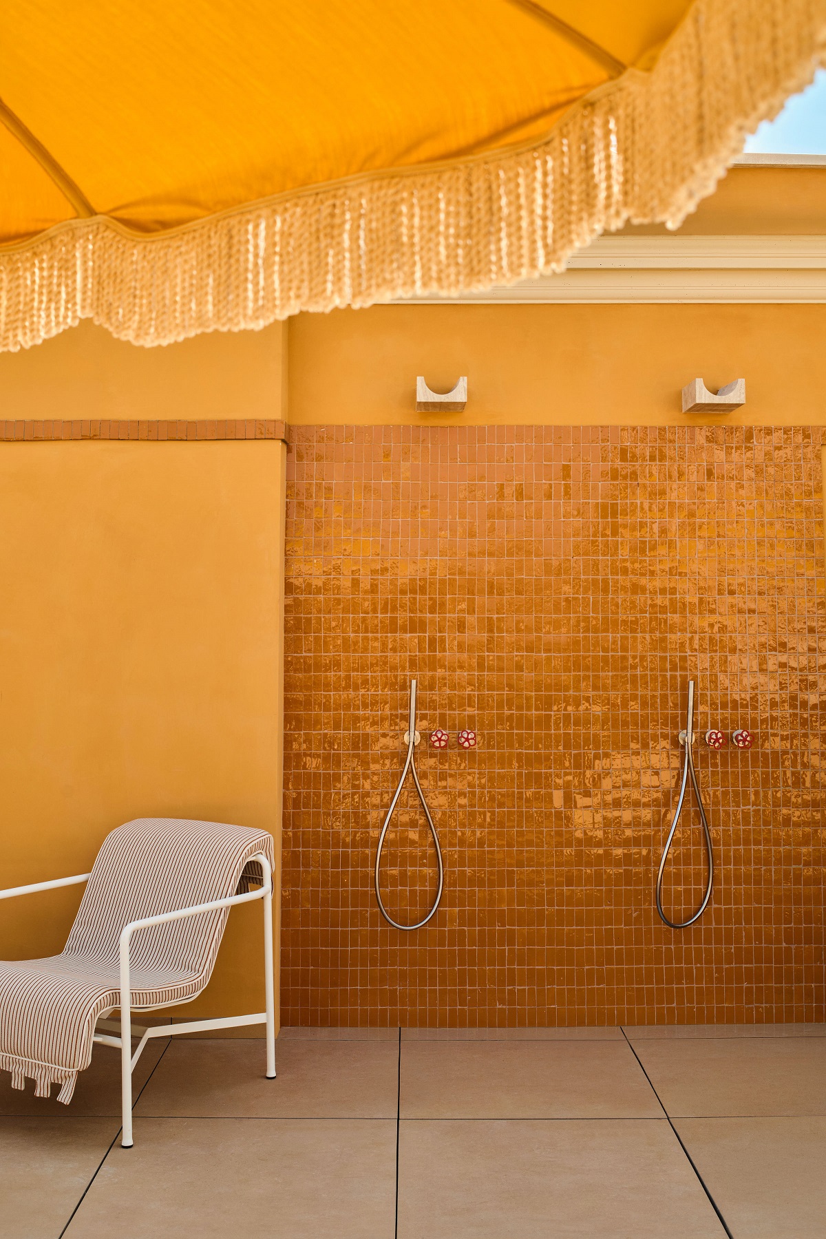 yellow wall and parasol detail in Experimental Roma roof terrace
