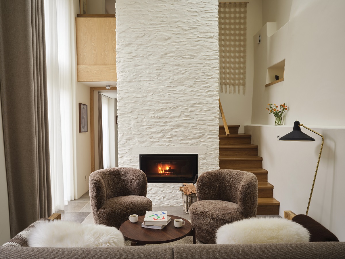 seating and fireplace in the tall barn at Fowlescombe Farm
