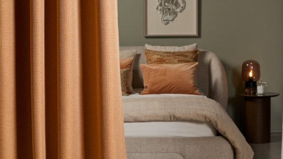 curtain draped in front of bed - Edmund Bell contract blackout fabric