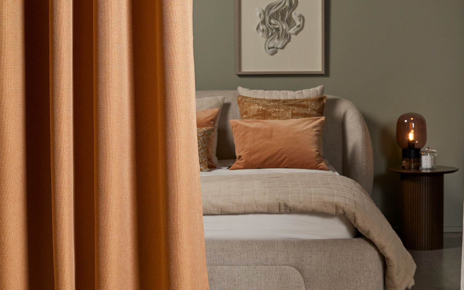 curtain draped in front of bed - Edmund Bell contract blackout fabric