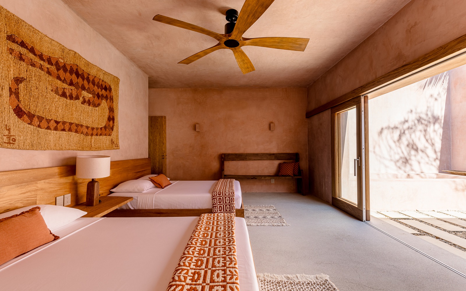 earthy tones, wooden fan, woven wallhanging in Casa Coco