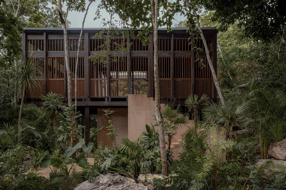 La Valise Bacalar wooden cabin on stilts in natural landscape