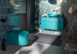 bathroom with bright blue Duravit toilet and vanity with walls in bold botanical wallpaper