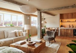 wooden coffee table and cream couches in suite at 1 Hotel Copenhagen