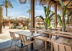outdoor tables and chairs on the beach at INNSiDE by Meliá Wave Calviá