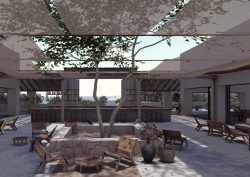 central courtyard with a tree and canopy surrounded by seating and hotel lobby
