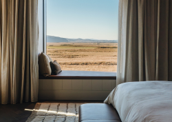 bed and window seat with panoramic icelandic view in 360 Hotel