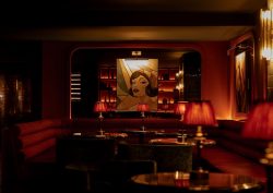 dark red interior, low lighting and vintage pin ups in Hush