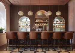 brown leather bar seats lined up against the bar in the Intercontintal in Rome