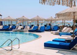 sunbeds and swimming pool at Brown Beach Eretria by Brown Hotels