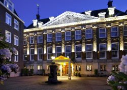 exterior period facade of Sofitel Legend The Grand Amsterdam lit up at night