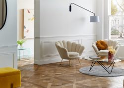 apartment with wood parquet flooring, white walls and cream and mustard furniture