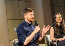 artiq on stage discussing art in hotels