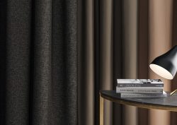 curtains in brown and charcoal from Sekers ESME collection behind a table with books and reading lamp