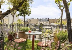 bistrot chairs and a glass of wine on the roof terrace in Parisian hotel La Fantaisie