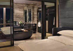 Bedroom at the Equinox Hotel New York looking into the luxury hotel bathroom