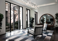 greyscale room with french doors overlooking courtyard with tree in centre