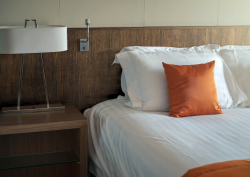 Close up shot of bed and sidetable with headboard decorate in walnut architectural film