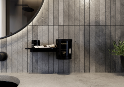 Flaky soap grinder and dispenser by ALISEO, in black on grey tile background