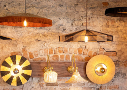 Selection of Mullan lighting creations hung on bare brick wall