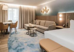 Organically shaped custom rug in Hotel Sliema guest room, designed by Studio Fabris and produced with Axminster weaving technique