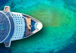 Birds-eye-view of cruise ship on turquoise green sea